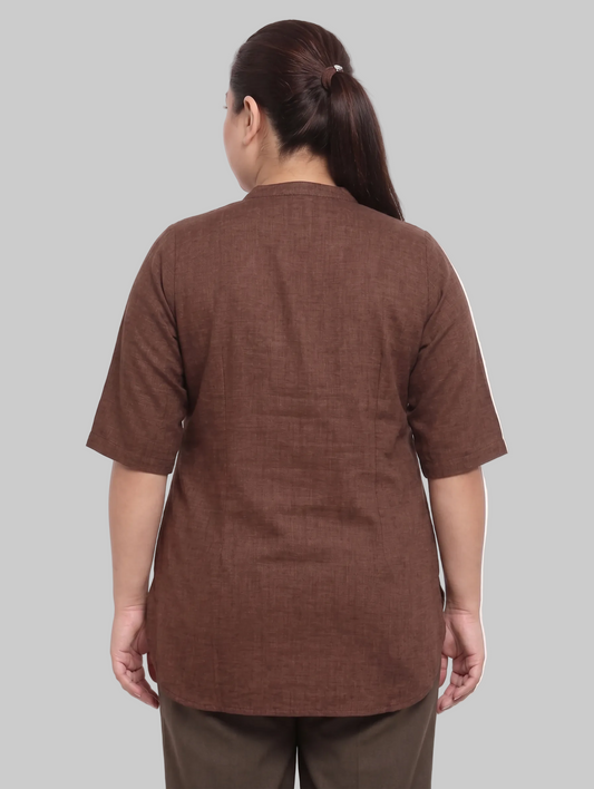 Person wearing a brown shirt and pants on a white background
