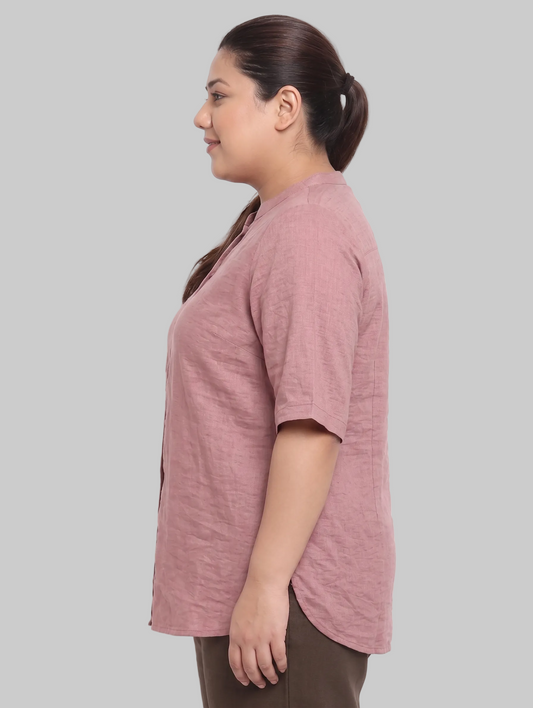 Woman wearing a pink shirt against a white background