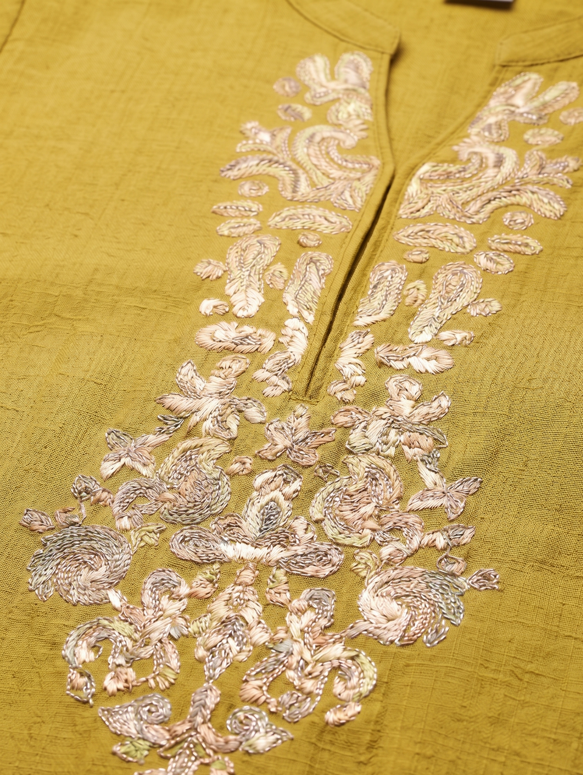Mustard yellow fabric with intricate silver embroidery