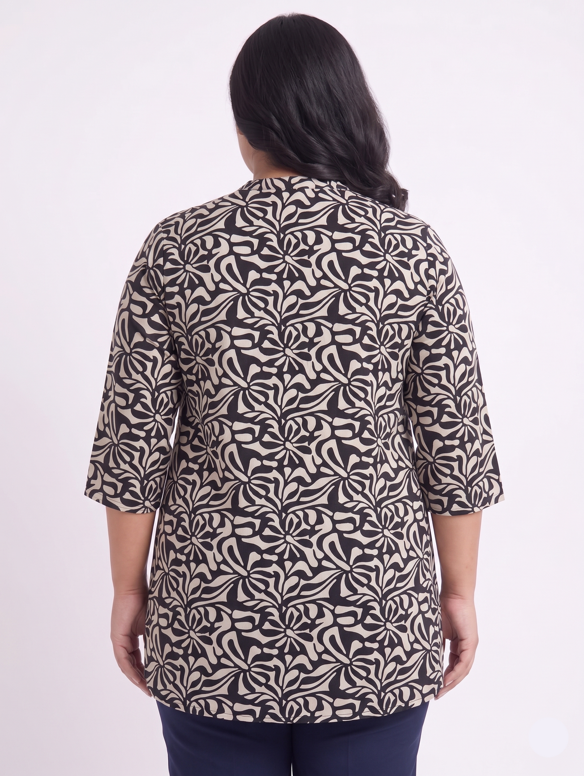 Woman wearing a patterned shirt on a white background