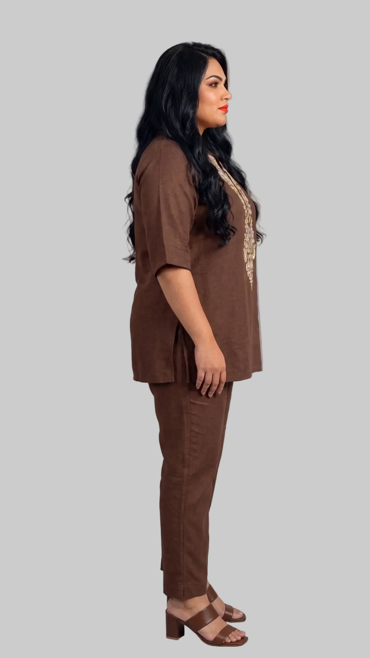 Woman wearing a brown outfit against a gray background