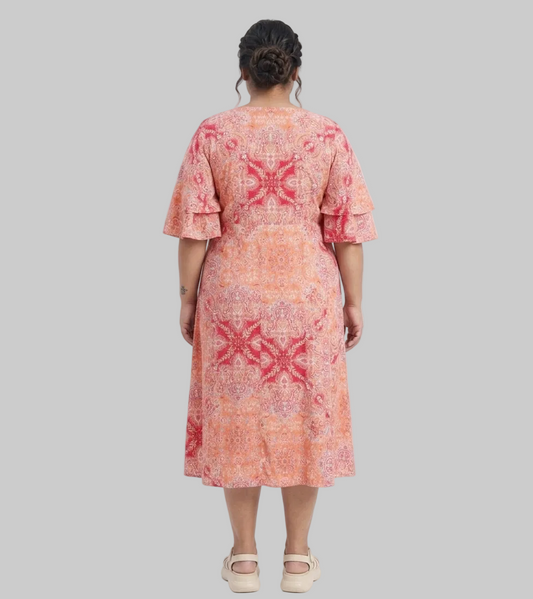 Woman wearing a patterned dress on a white background