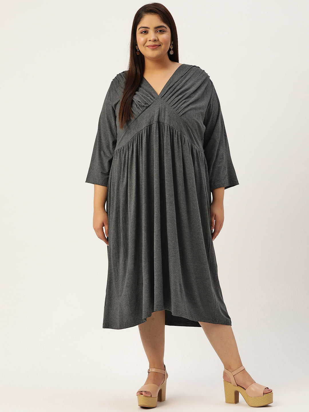 Woman wearing a gray dress on a white background