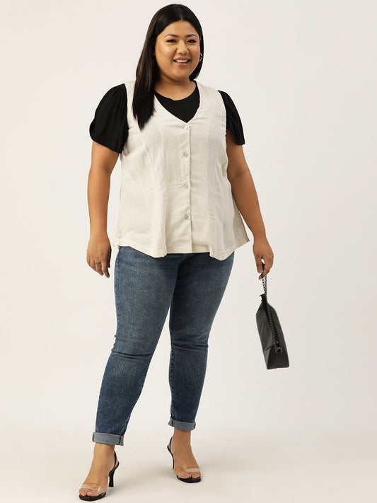 Woman wearing a white blouse, black top, blue jeans, and holding a black handbag on a white background