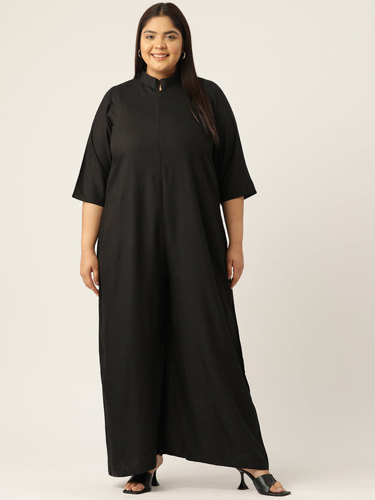Woman wearing a black dress against a plain background