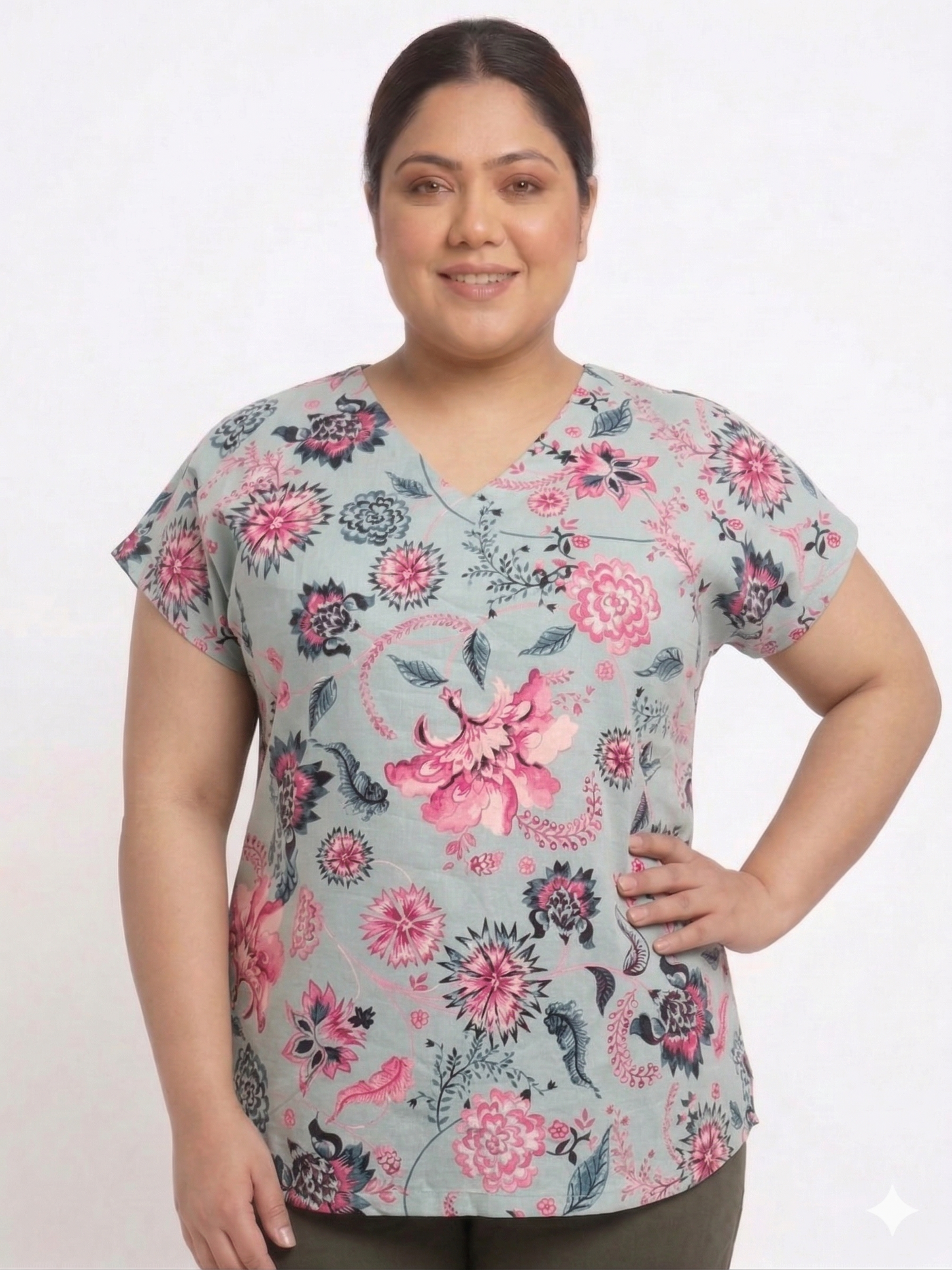 Woman wearing a floral patterned top on a white background