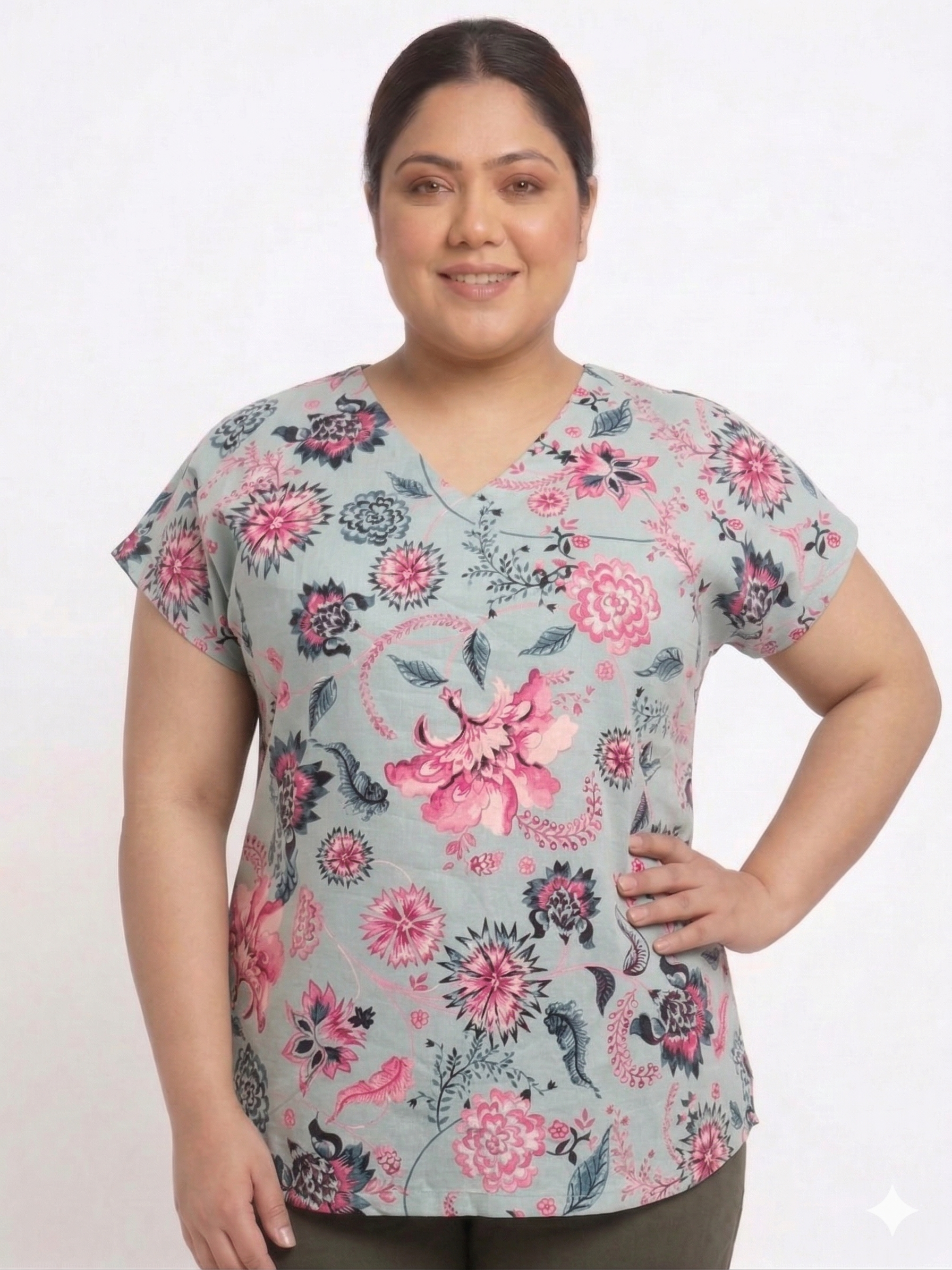 Woman wearing a floral patterned top on a white background