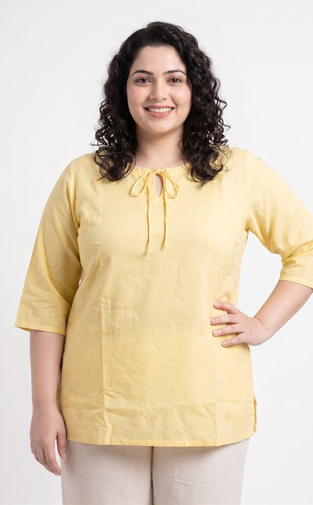 Woman wearing a yellow blouse with a white background