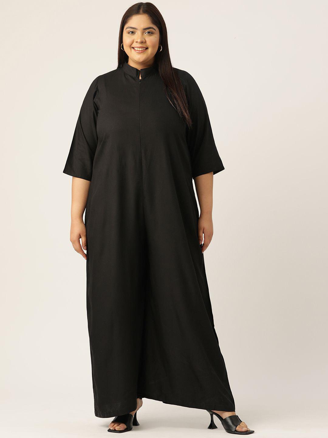 Woman wearing a black dress against a plain background