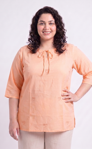 Woman wearing an orange blouse with a white background