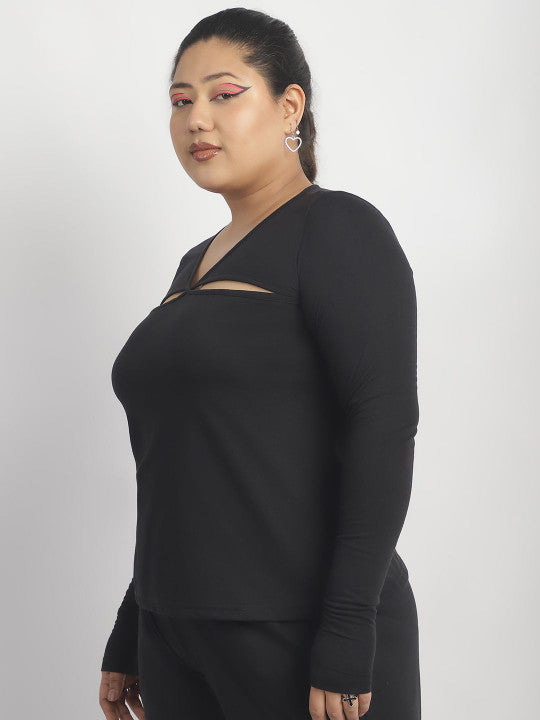 Woman wearing a black long-sleeve top with cut-out design on a white background