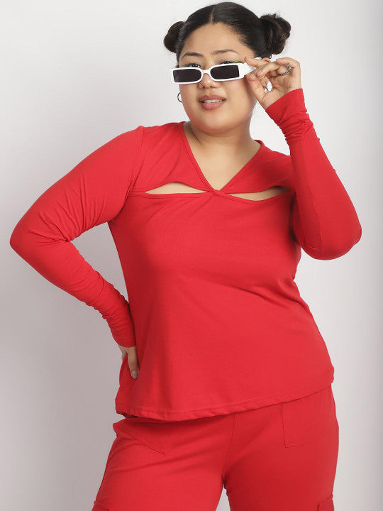 Person wearing a red outfit with cut-out design on a plain background